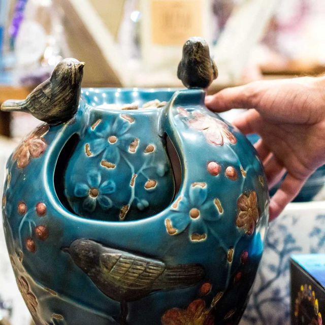 decorative large ceramic vase with two ceramic birds on top